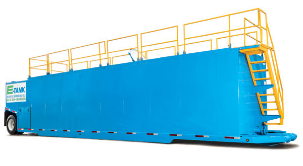 E-Tank’s new products - 18,400-gallon double wall tank featuring a bright blue design with yellow safety railing, engineered for environmental containment and secure liquid storage on job sites.