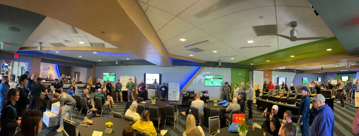 E-Tank hosting community event with attendees at indoor venue, supporting local initiatives and networking with industry partners
