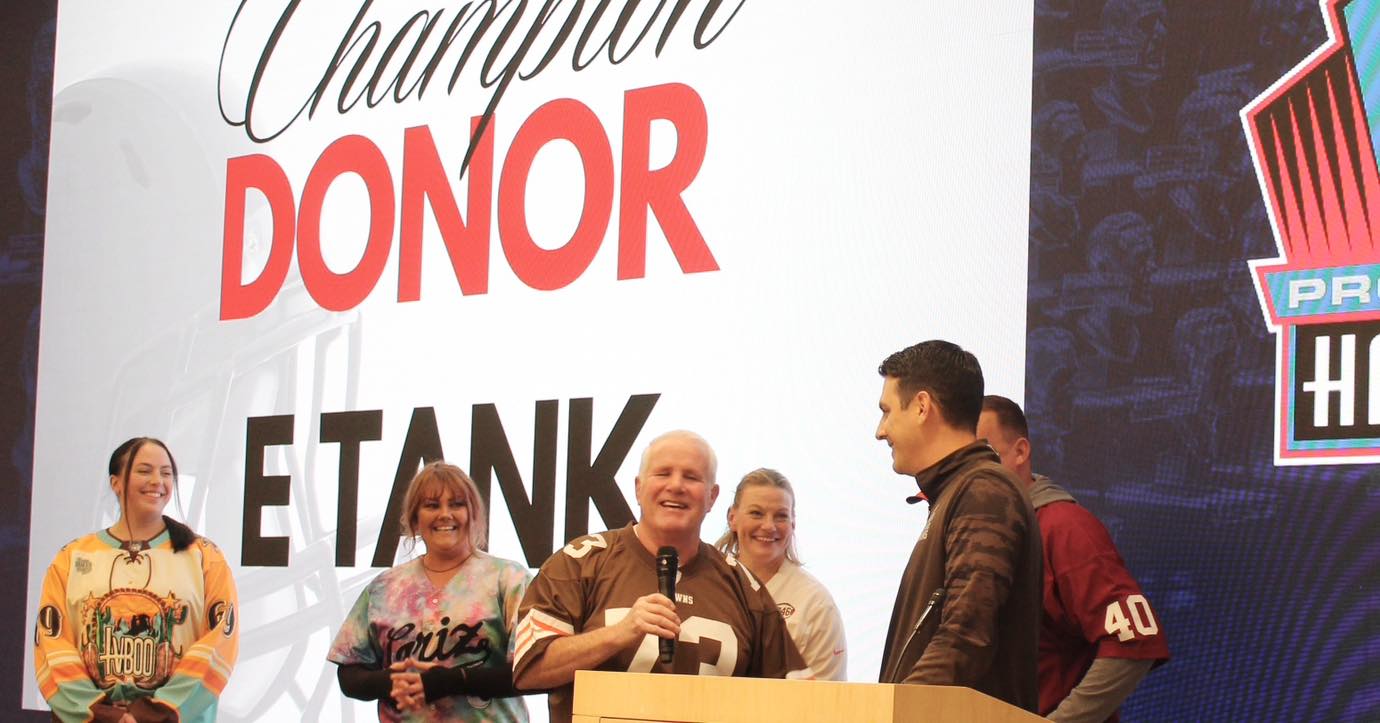 E-Tank team on stage at Pro Football Hall of Fame in Canton, Ohio, being honored as Champion Donor for community support initiatives