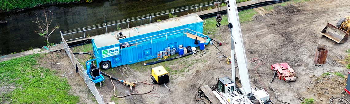 Construction equipment rentals with large-capacity tanks, pumps, and filtration systems staged for excavation and site dewatering.